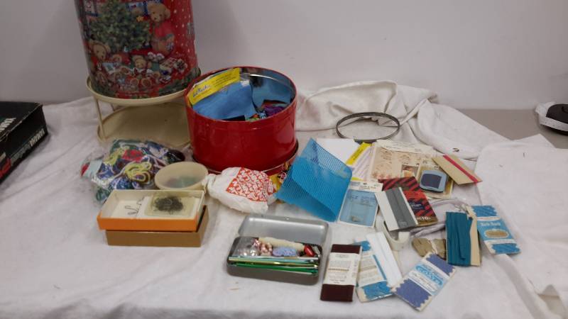 lot 30 image: Tins full of crafting and rotating cake plate