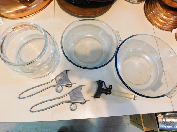 two pyrex serving bowls with three pyrex handles and one glass bowl