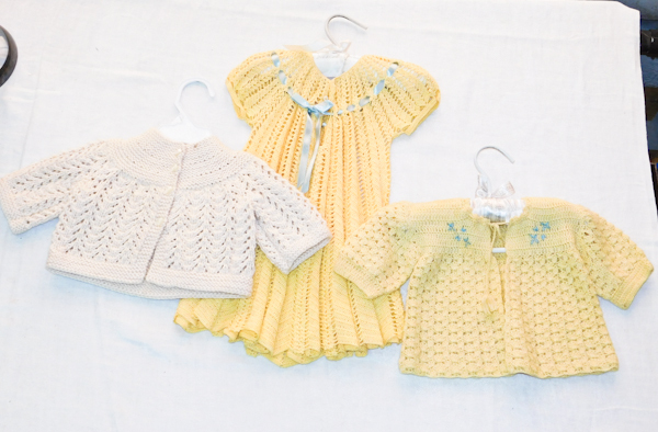 3 small hand knitted pieces an infant sized dress and 2 sweater jackets