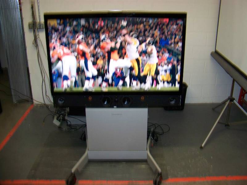 lot 13 image: 52, TanbergCisco Monitor  Display on Heavy-Duty Rolling Cart with Speaker Bar and Input Panel