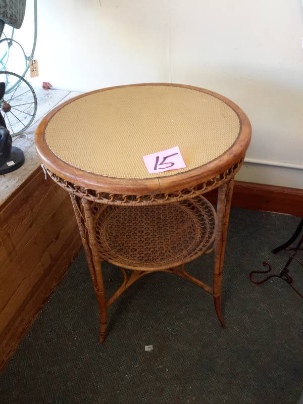lot 15 image: Wood Wicker side table with caned top. Top painted. Overall nice shape.  25in diameter x 29in h
