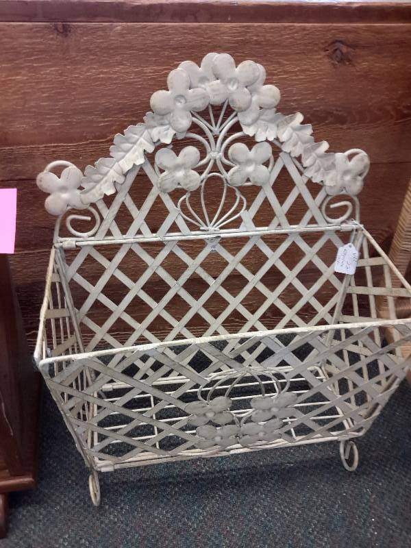 lot 16 image: 2, magazine racks. 1 wood with spindles, 1 wrought iron, Painted.