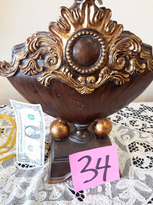 lot 34 image: Unique Table lamp with hat type shade.  Simulated wood and gold guild type painted trim.. Electric.. Nice shape, but untested
