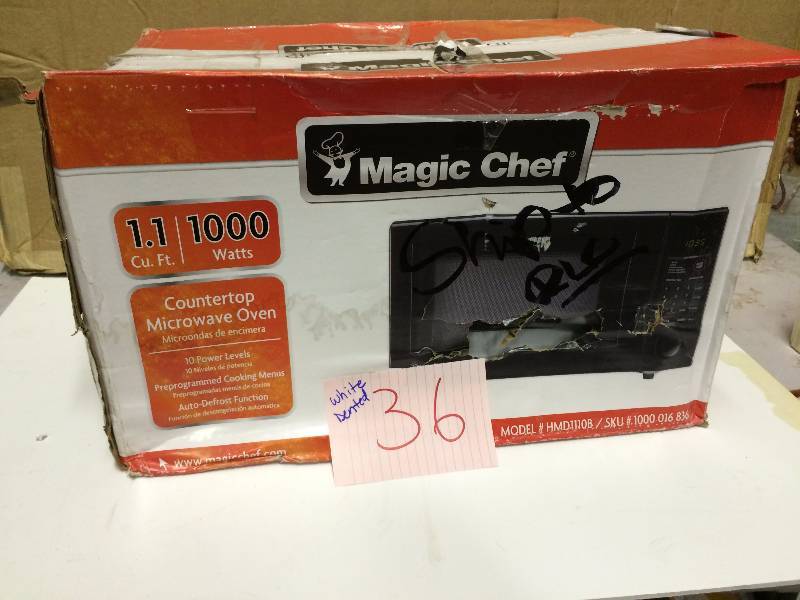 lot 36 image: Magic Chef 1.1 cu. ft. Countertop Microwave in Black Dented in the back