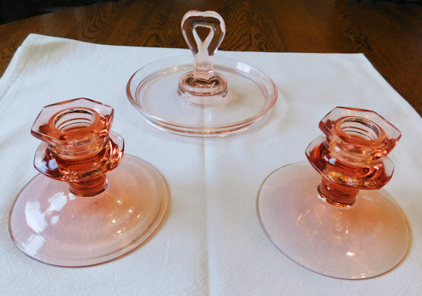 three pink depression glass items serving dish with heart shaped handle