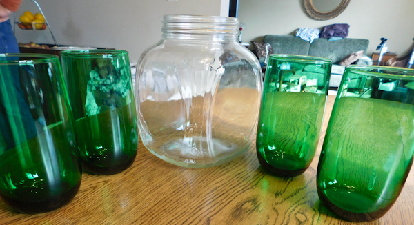 4 green drinking glasses and a vintage clear coffee jar