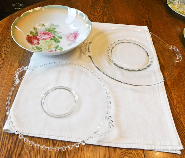 two clear glass cake plates and a German china serving bowl
