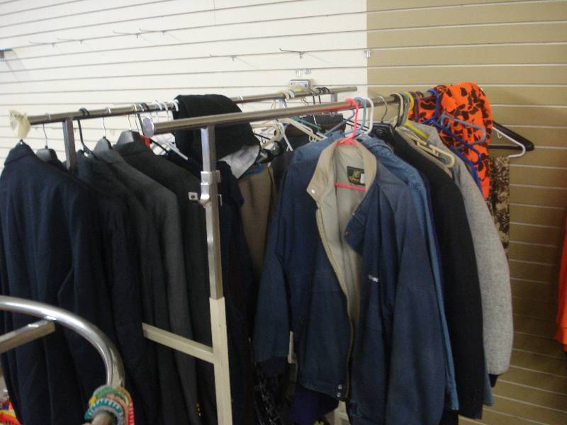 Clothes rack filled with coats, out...