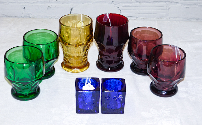 colorful lot of goblets and two blue candle holders 1 goblet has a chip