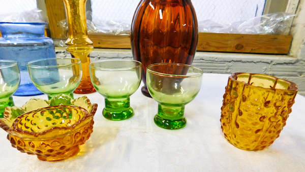 Amber colored Fenton votive and assorted colored glass decor