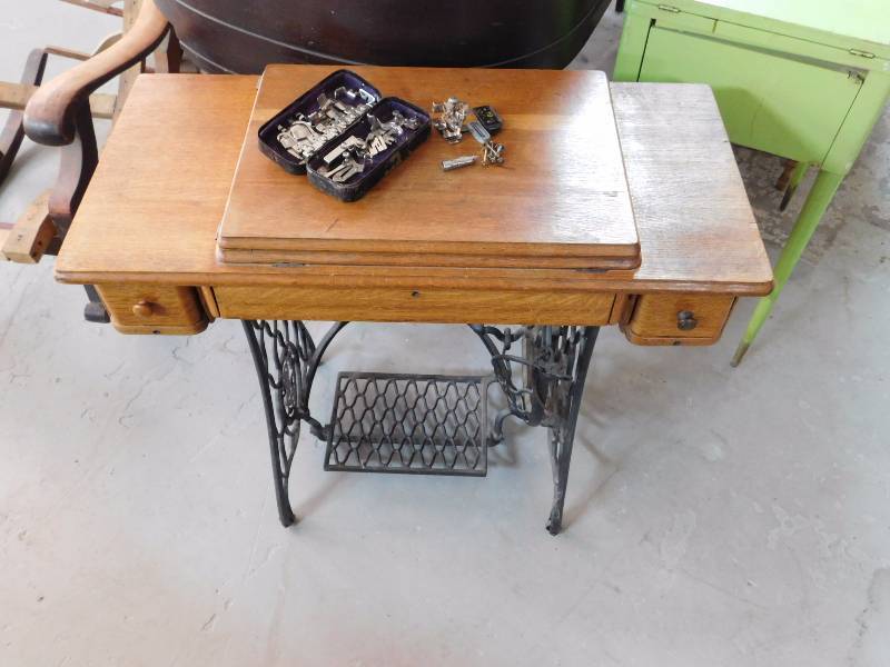 Singer treadle sewing machine in wooden cabinet with two drawers