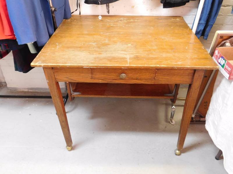 Vintage library table there is a  drawer and a lower shelf for storage.