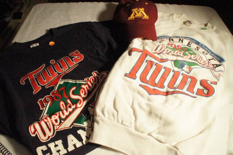 lot 507 image: Collectible Twins Sweatshirt from 1987 World Series, Minnesota Twins T-Shirt from 1987 and Minnesota Golden Gopher Baseball Cap