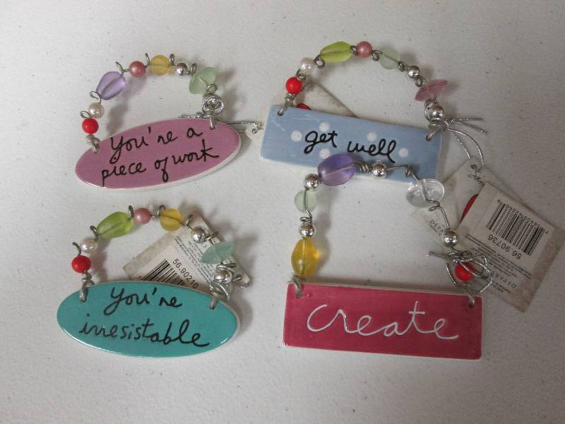 Lot of 4 assorted charm tiles...