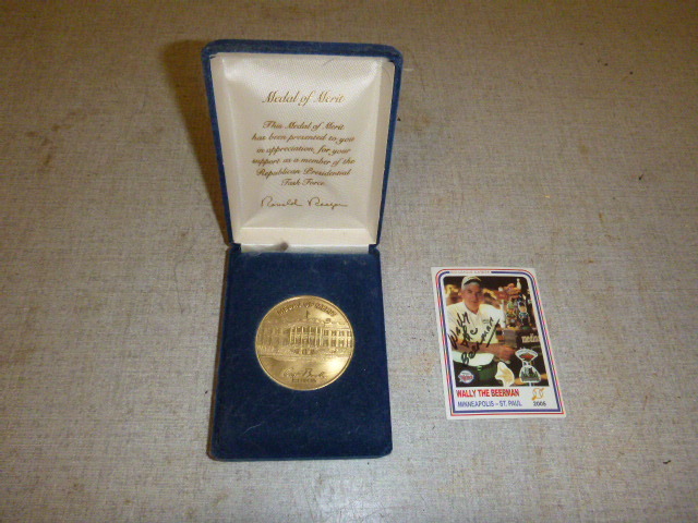 lot 19 image: Metal of Merit and Signed Wally the Beerman Card