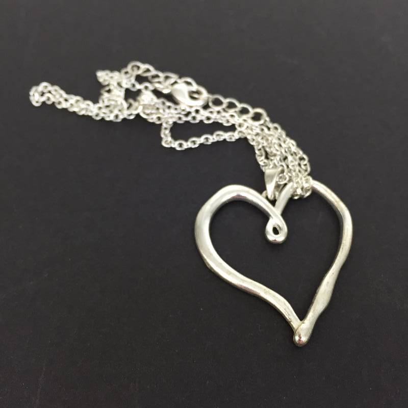lot 96 image: Heart Shaped Pendant.. We think it is Sterling.. Non magnetic and seems soft.