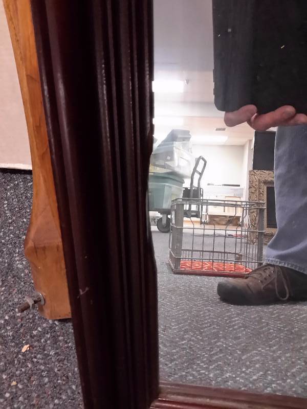 lot 135 image: Mirrror with nice wood frame.. Small chip of wood broken away on edge of mirror.  Approx 24in x 40 in dim