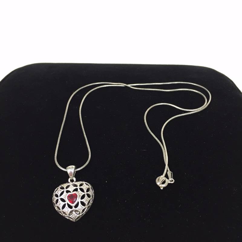 lot 107 image: Sterling Silver necklace with red stone (not sure of type) AVON.