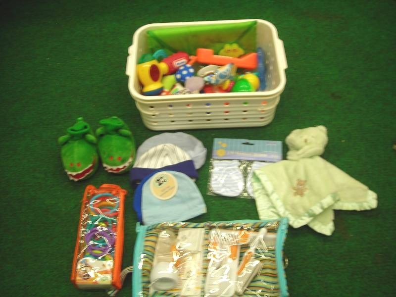 lot 15 image: Lot Of Baby ToysRattles, Slippers, Caps, Grooming Kit