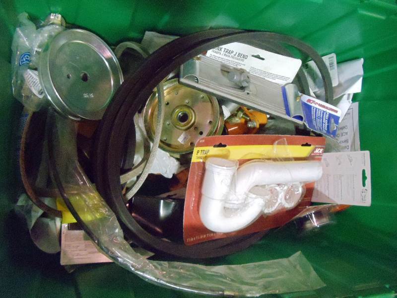 lot 64 image: NEW Misc Lot incl Lawn Mower Blades and Parts, Pully Wheels, Plumbing Parts and More. Entire contents of Box. Green Bin NOT Included