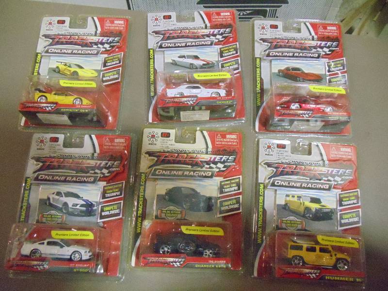 lot 212 image: NEW Qty 6 Tracksters Die Cast 164 Scale Toy Cars with Access Code for Online MMOG Gaming