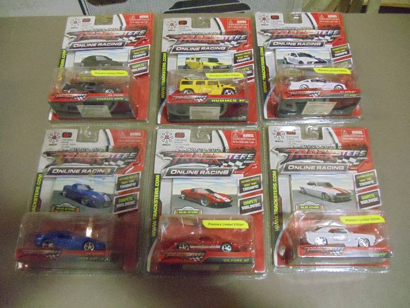 lot 217 image: NEW Qty 6 Tracksters Die Cast 164 Scale Toy Cars with Access Code for Online MMOG Gaming