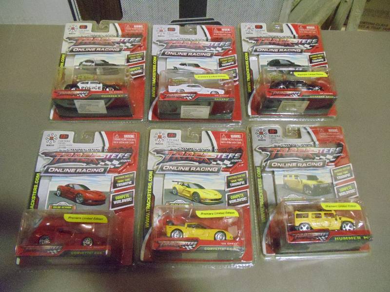 lot 318 image: NEW Qty 6 Tracksters Die Cast 164 Scale Toy Cars with Access Code for Online MMOG Gaming