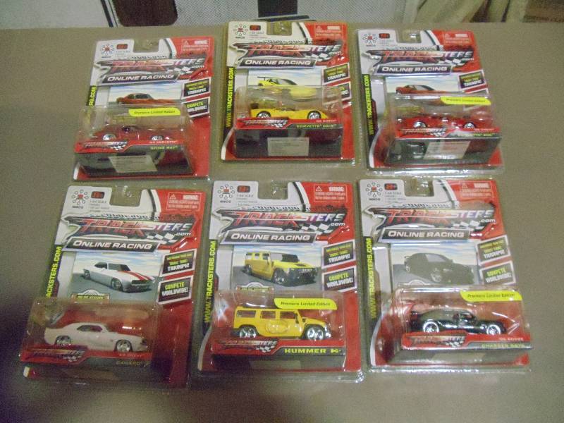 lot 319 image: NEW Qty 6 Tracksters Die Cast 164 Scale Toy Cars with Access Code for Online MMOG Gaming