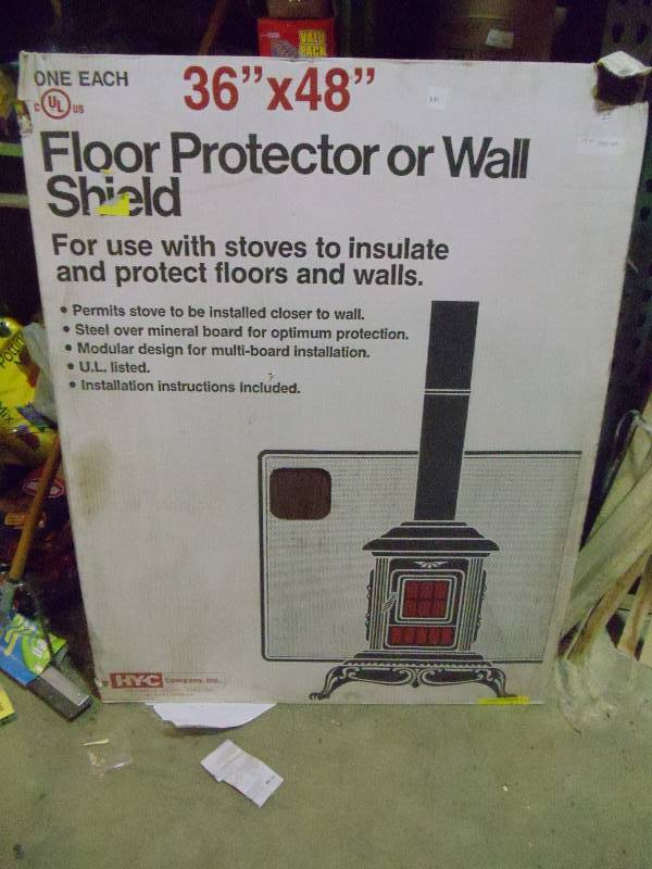 lot 381 image: NEW 36x48 in WallFloor Heat Shield Used with Fireplaces, Stoves and Ovens to Protect Floors or Walls From Heat. Walnut Finish. One Corner Slightly Dented Does Not Affect Function
