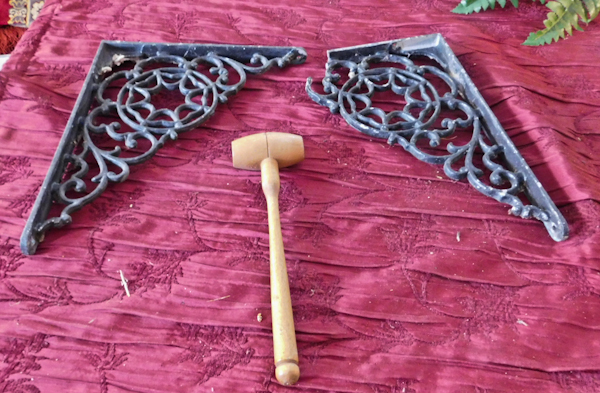 lot 177 image: two metal brackets one has a break and wooden nut cracker hammer