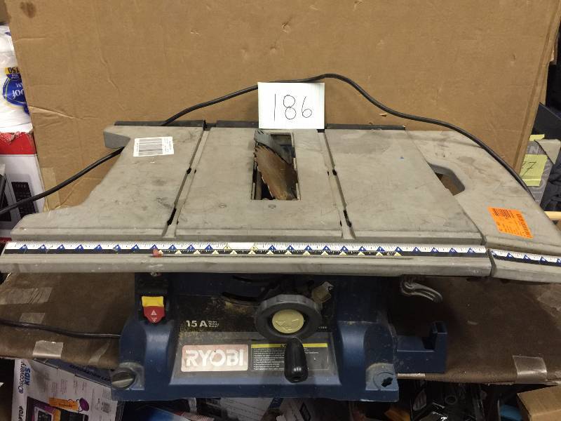 lot 186 image: Ryobi 10 in. Portable Table Saw- broken base missing parts- machine works could be used for parts or repair