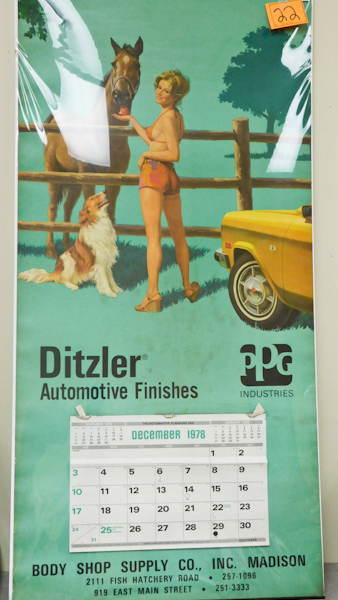 lot 22 image: Vintage Auto Shop, Indi Car Pin-Up Girl CalendarPoster.