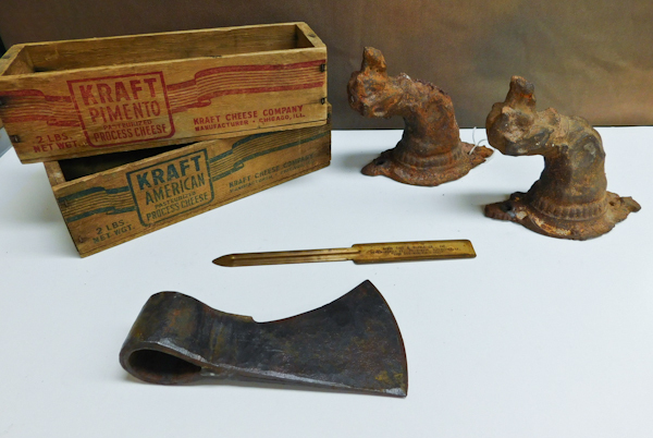lot 174 image: two cast iron dogs, two Kraft cheese boxes hatchet head