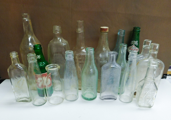 lot 197 image: collection of bottles blue clear and green. Soda and whiskey bottles