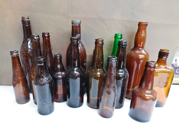 lot 198 image: collection of bottles brown amber and green . Soda and whiskey bottle