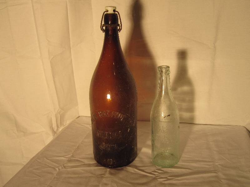 lot 19 image: 2 vintage embossed beer bottles