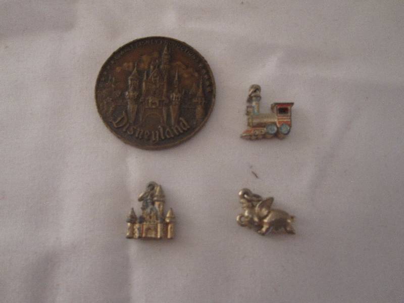 lot 95 image: Vintage 1950s Disney charms and Disneyland coin