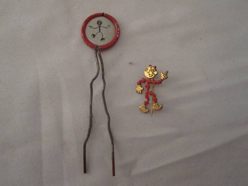 lot 101 image: 2 Vintage Reddy Kilowatt pins