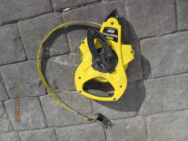 lot 9 image: Power winder 100 foot tape measure...