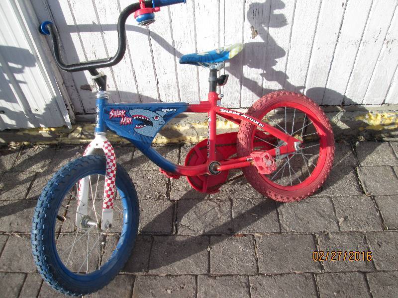lot 26 image: Shark attack red and blue bike...