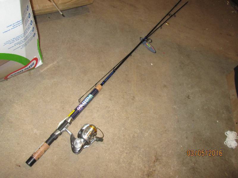 lot 113 image: New fishing reel, on a rod that is ...