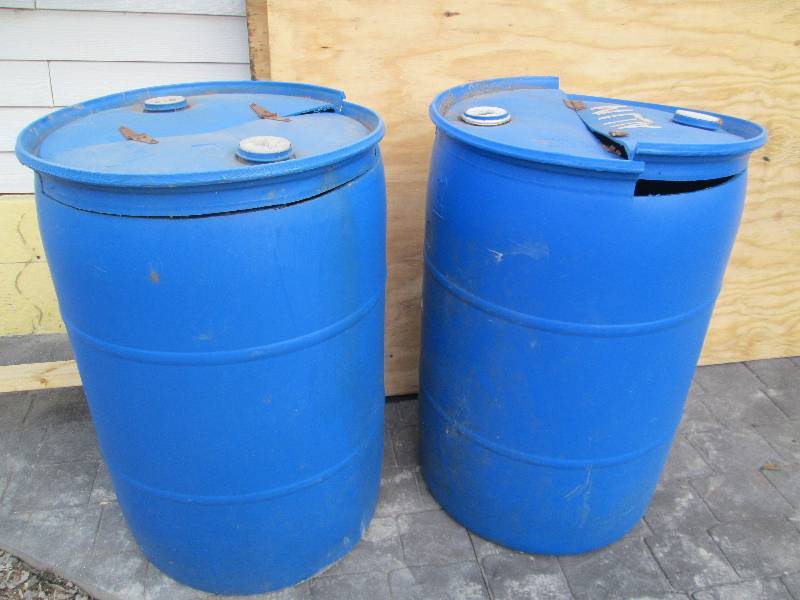 lot 177 image: 2 blue plastic 55 gallon barrels wi...