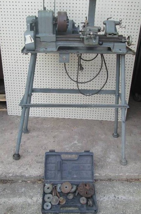 lot 1 image: Antique lathe on stand, includes bo...