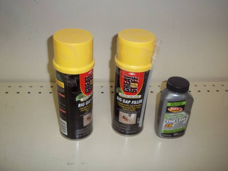 lot 105 image: 2 cans of gap filler and bottle of radiator stop leak