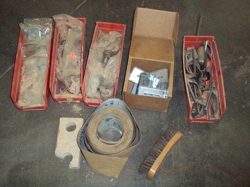 lot 217 image: New Cabinet hinges  with 4 red  plastic bins, drawer pulls, tape and brush