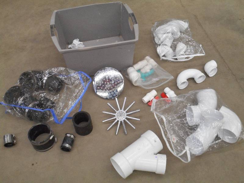 lot 60 image: Tote Full Of PVC & Rubber Pipe Fitt...