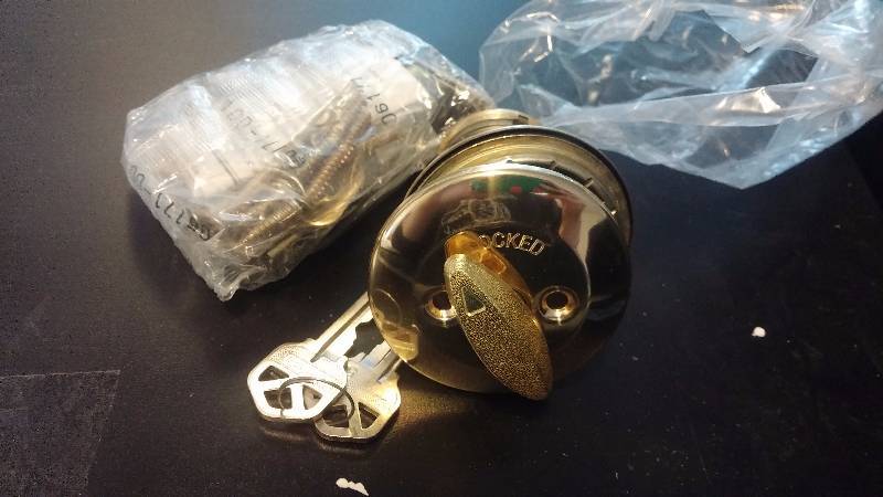 lot 41 image: Kwikset Deadbolt in polished brass