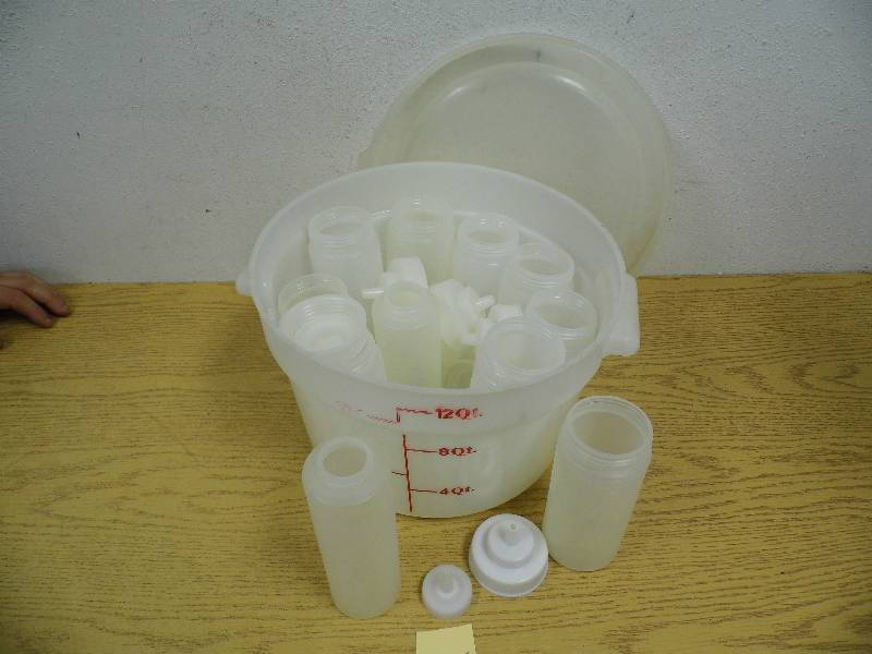 lot 55 image: 12 Quart Container w Condiment Bottles
