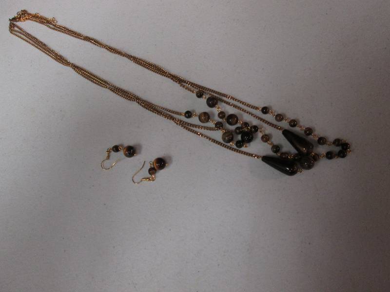 lot 106 image: Matching gold amber colored beads ...