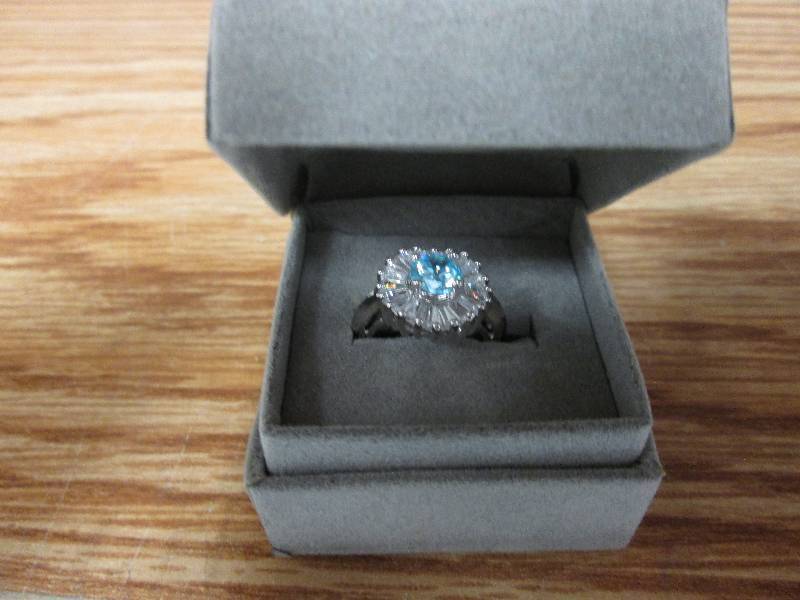 lot 4 image: Sterling silver ring with blue ston...